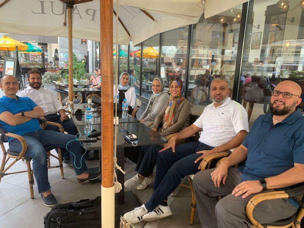Members sitting outside coffee shop