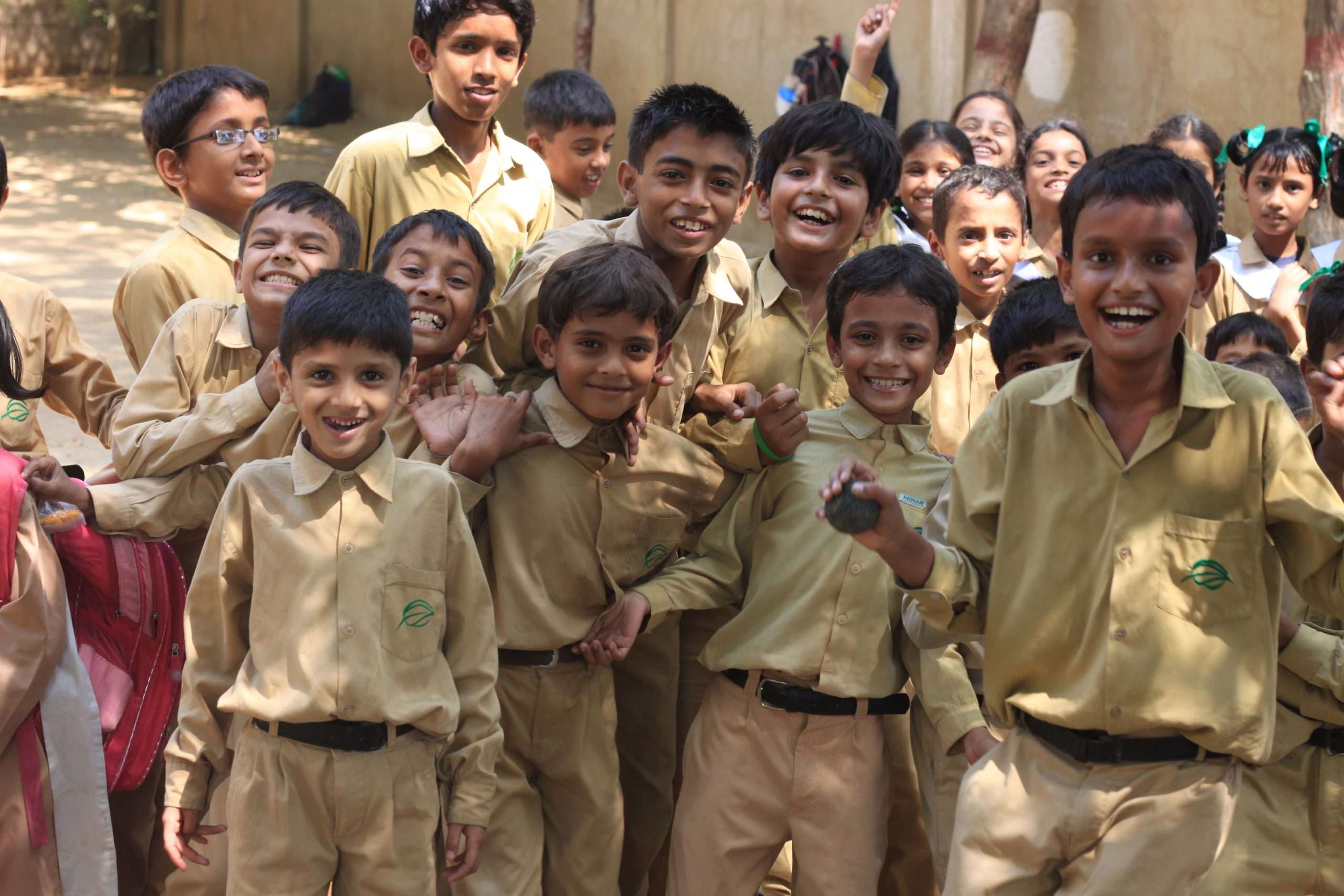 chaotic group of smiling children in school uniform